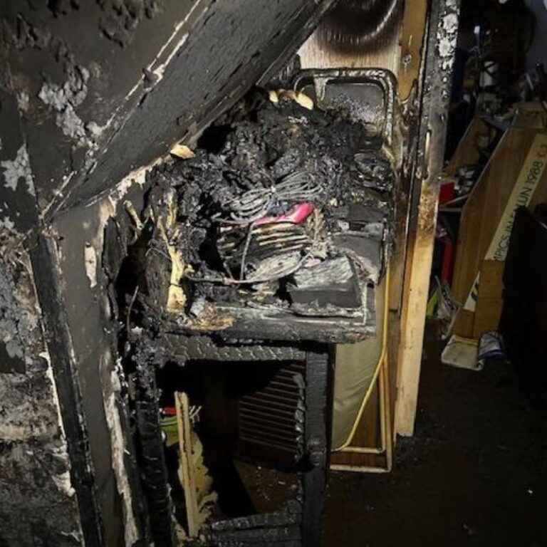 A photo of a corner of a room covered in smog and soot from a house fire