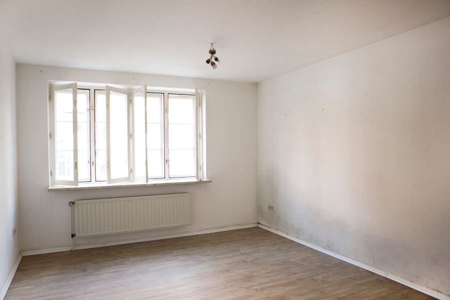 a white room with mould stains on the wall after a clean