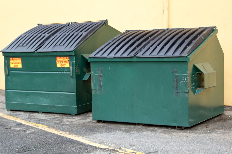 2 green industrial bin stores ready to be cleaned