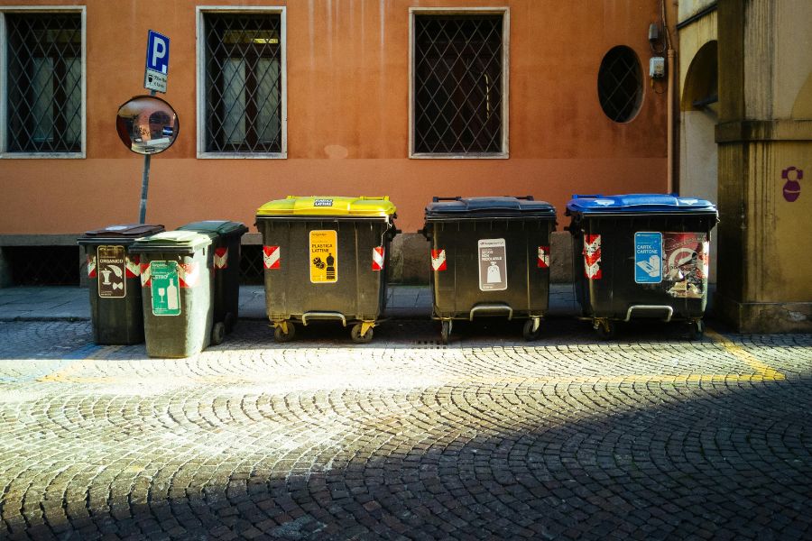 industrial bin stores ready to be cleaned in front of a building
