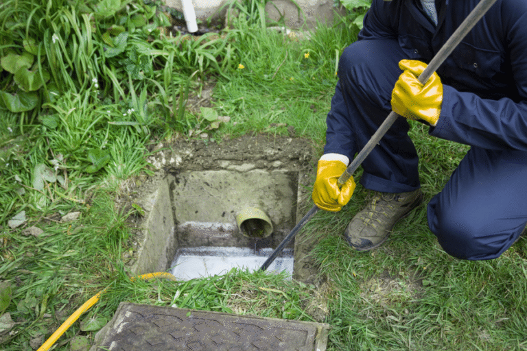 a garden with the drain lid removed and being inspected