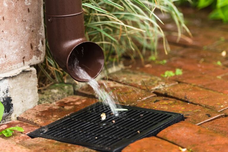 a garden drain with water running into a drain