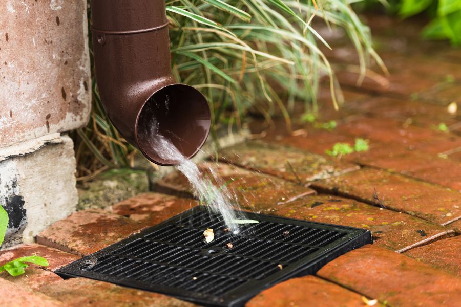 a garden drain with water running into a drain