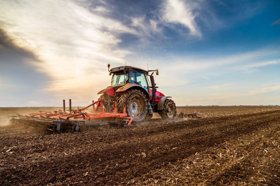 a tractor ploughing fields, in need of a trailer washout