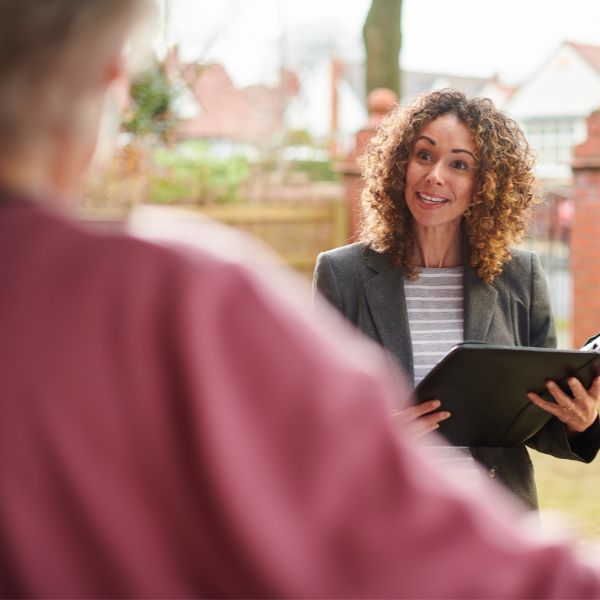 Property professional speaking with tenant during residential property inspection or handover